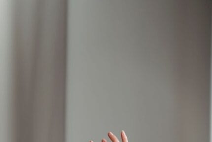 anonymous woman performing dance with raised arms in studio