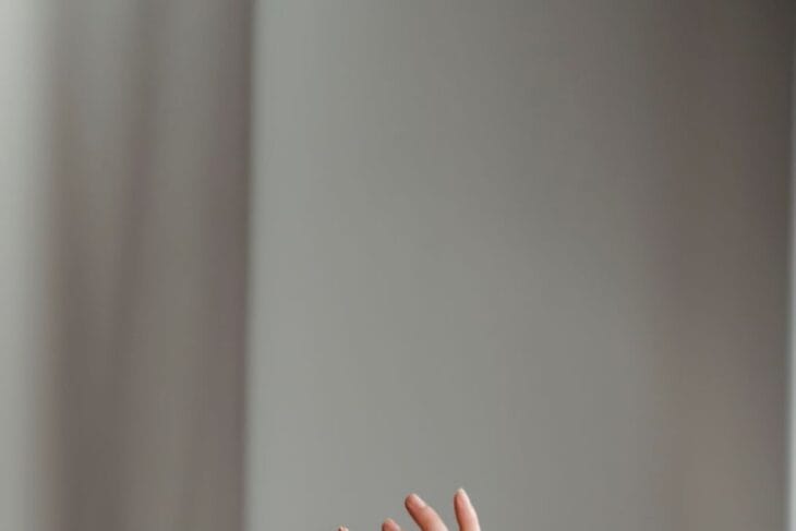 anonymous woman performing dance with raised arms in studio