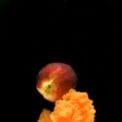 photo of a peach on top of an orange smoke